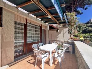 a patio with a table and chairs on a balcony at Giglio Gold in Giglio Porto