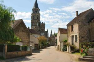 an empty street in a village with a church at Appartement Lilas in Saint-Père