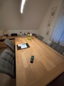 a conference room with a wooden table with a phone on it at fewo-brigitte in Buxtehude