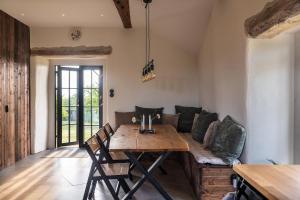 a living room with a wooden table and a couch at Windmill with the best sunset view in Borgholm +35 photos
