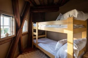 two bunk beds in a room with a window at Windmill with the best sunset view in Borgholm