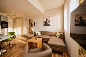 a living room with a couch and a table at ADAPT APARTMENT HOTEL Siegen in Siegen