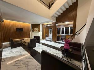 a living room with a couch and a table at Nana Grand Hotel Yerevan in Yerevan