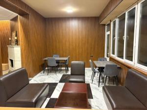 a waiting room with a couch and a table and chairs at Nana Grand Hotel Yerevan in Yerevan +32 photos