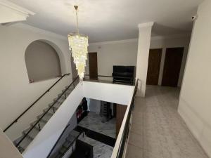 a staircase in a house with a chandelier at Nana Grand Hotel Yerevan in Yerevan