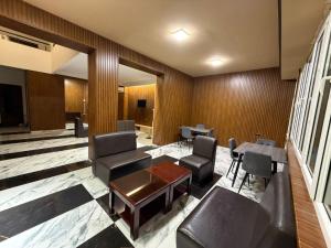 a waiting room with chairs and a table in a building at Nana Grand Hotel Yerevan in Yerevan