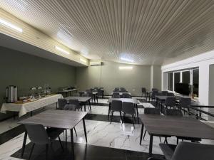 a dining room with tables and chairs and a room filled with tables at Nana Grand Hotel Yerevan in Yerevan +26 photos