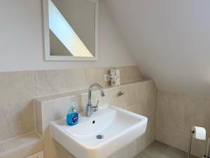 a bathroom with a sink and a mirror at 1320 - "Haus Maria" in Dahme +11 photos