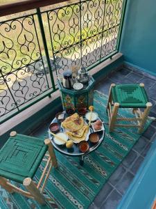a plate of food on a table on a balcony at La Perle de Neige in Imlil