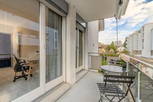 a balcony with a table and chairs on a balcony at Copper Suite · Seebach in Zurich +14 photos