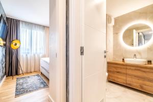 a bathroom with a sink and a mirror at Arena Lux Apartments in Zagreb