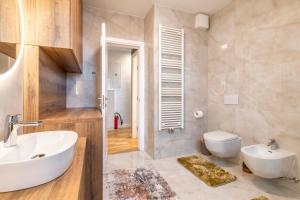 a bathroom with a white sink and a toilet at Arena Lux Apartments in Zagreb +56 photos