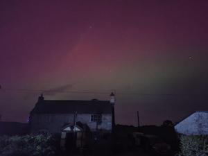 a night view of a house with a purple sky at The Stables Inn in Minsterley