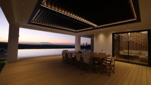 a dining room with a table and a view of the water at Sani Chateau in Sani Beach