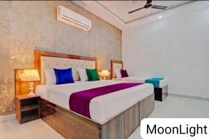 a bedroom with two beds in a room at The MoonLight Hotel in Zirakpur
