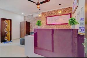 a lobby with a pink sign on a wall at The MoonLight Hotel in Zirakpur