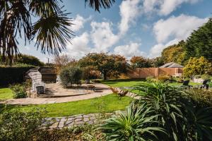 a garden with a stone walkway in a yard at Lower Barns Boutique B&B in St Austell +1 photo