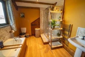 a bathroom with a tub and a sink and a mirror at The Stables Inn in Minsterley +18 photos