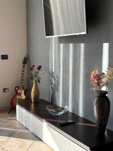a kitchen with a counter with a vase of flowers at Appartamento Accogliente tra Borghi e Natura in Castelluccio dei Sauri