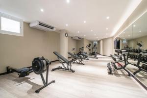 a gym with a row of treadmills and machines at Hotel Costa Málaga - Adults Recommended - by Pierre & Vacances in Torremolinos
