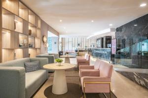 a lobby with couches and a table and chairs at Hotel Costa Málaga - Adults Recommended - by Pierre & Vacances in Torremolinos