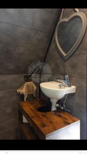 a bathroom with a sink and a mirror at L écureuil in Granges-Aumontzey