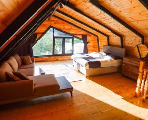 a bedroom with a bed and a couch in a attic at Tina Bungalov in Sapanca +23 photos