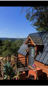 a wooden cabin with a door and a balcony at L écureuil in Granges-Aumontzey +12 photos
