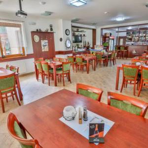 a dining room with tables and chairs in a restaurant at Marina Orlík in Kowářow +6 photos