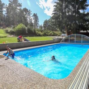 two people swimming in a large blue swimming pool at Marina Orlík in Kowářow