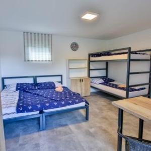 a bedroom with two bunk beds and a table at Marina Orlík in Kowářow