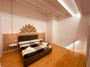 a bedroom with a bed and a wooden floor at Eureka Apartment in Noto