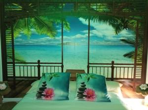 a bedroom with a bed with a view of the ocean at Gite et Studio "L'éclosion des Papillons" à 10 kms de Lens in Courrières
