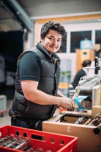 a man is standing in a store with a counter at Gasthof Diem in Krumbach