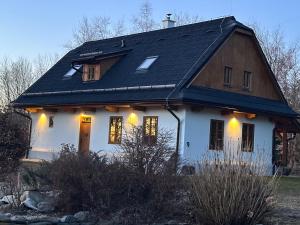 a white house with a black roof at Chalupa Vlachovice in Vlachovice +7 photos