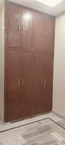 a row of wooden cabinets in a room at Nikunj dham in Vrindāvan