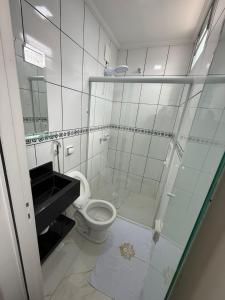 a bathroom with a toilet and a glass shower at Hotel Impactus Santo Amaro in São Paulo