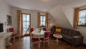 a living room with a couch and a table at Landhausferienwohnungen Am Brockenblick Pension in Sorge