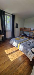 a bedroom with a large bed and a wooden floor at chambre dhote condat sur ganaveix in Condat-sur-Ganaveix +15 photos