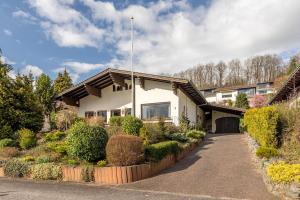 a house with a driveway in front of it at Green Eifel Casa in Feusdorf
