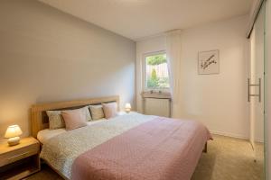 a bedroom with a large bed and a window at Green Eifel Casa in Feusdorf