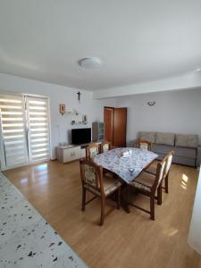 a living room with a table and chairs and a couch at Apartments Milevčić in Jelsa