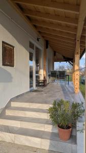 a porch of a house with stairs and a table at Ferienhaus Marcali - Erholung am Thermalbad und Plattensee in Marcali