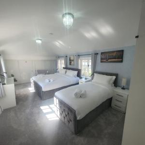 two beds in a large room with two beds sidx sidx sidx sidx at Luxury 6 bed house by the sea in Rhos-on-Sea