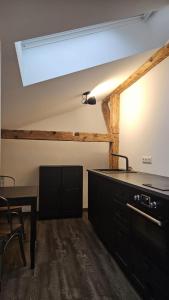 a kitchen with a sink and a table in a room at Endorfer Stubn in Bad Endorf