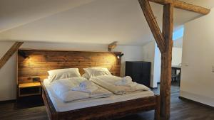 a bedroom with a large bed with towels on it at Endorfer Stubn in Bad Endorf