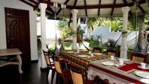 a table with a colorful table cloth on a patio at Premier Villa Tangalle in Tangalle