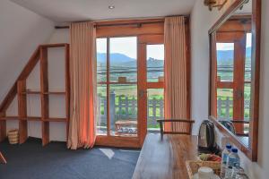 a room with a table and a large window at Villa Evermist in Nuwara Eliya
