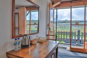 a kitchen with a table and a window with a view at Villa Evermist in Nuwara Eliya