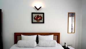 a bedroom with a bed with a x on the wall at Premier Villa Tangalle in Tangalle